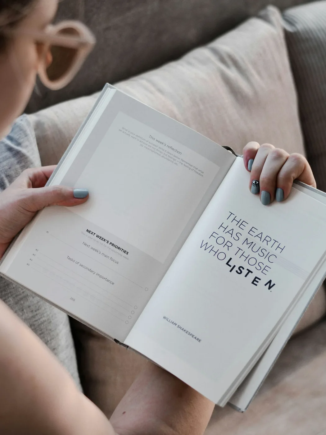 Open book held by a seated reader