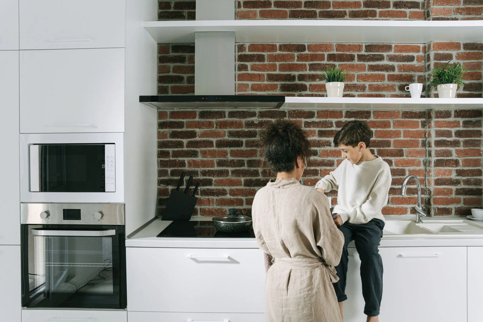 Two people talking beside a bright kitchen counter