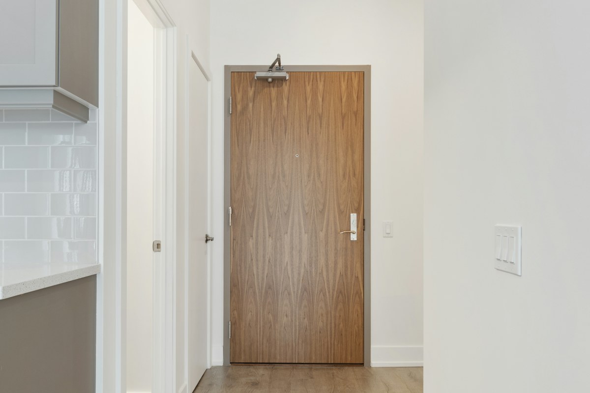 Wooden internal door beside a bright white wall